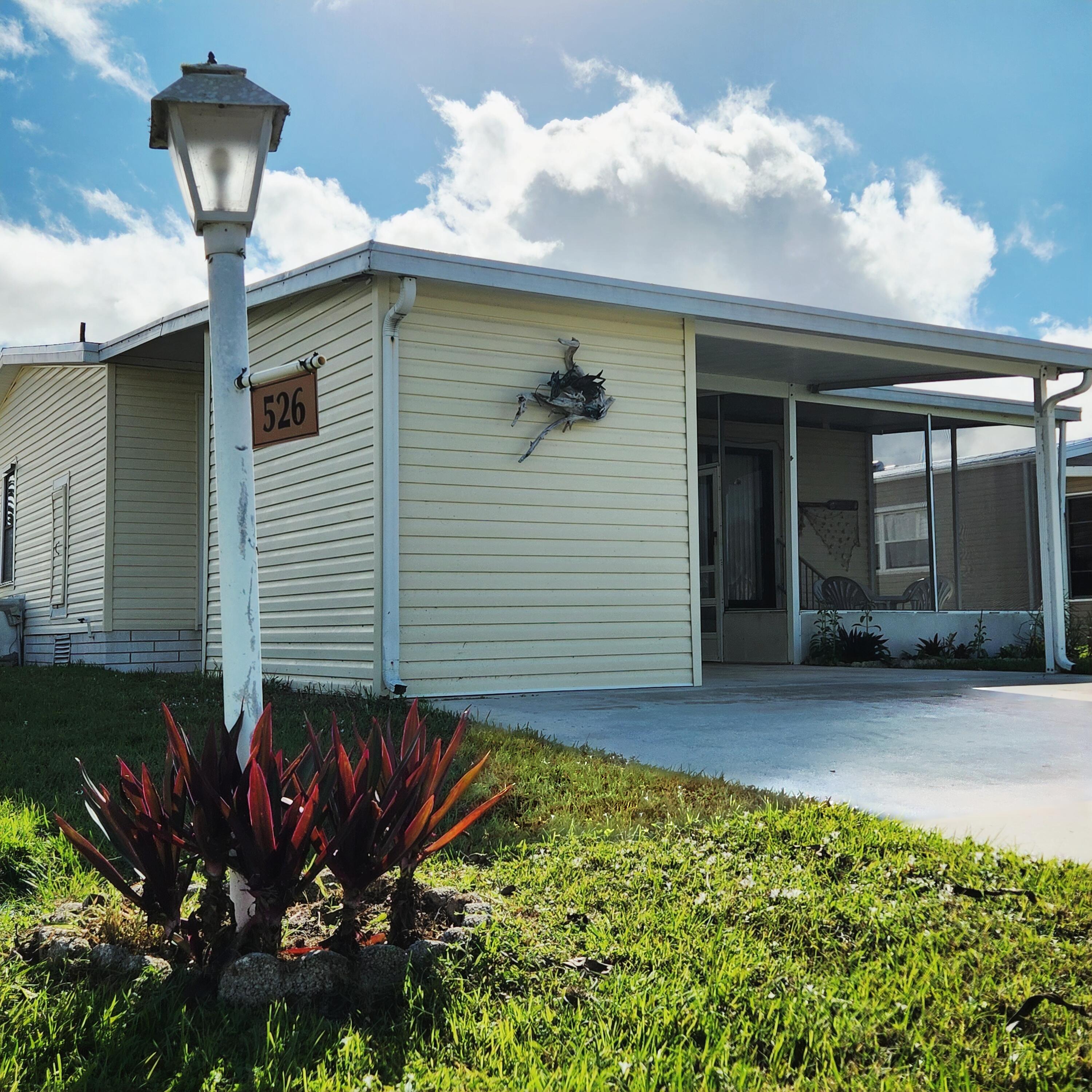 526 Hemingway Terrace, Unit F02 Fort Pierce, FL 34982 - Photo 50 of 55 a front view of a house with garden