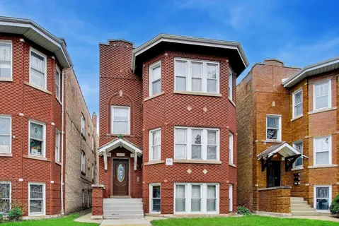 a front view of a residential apartment building with a yard