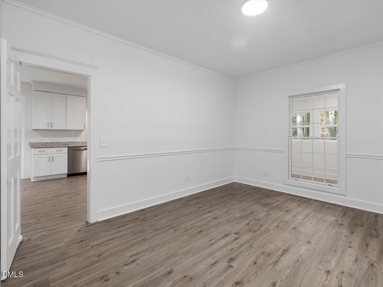 1838 Alex Cockman Road Pittsboro, NC 27312 - Photo 11 of 53 an empty room with wooden floor cabinet and windows