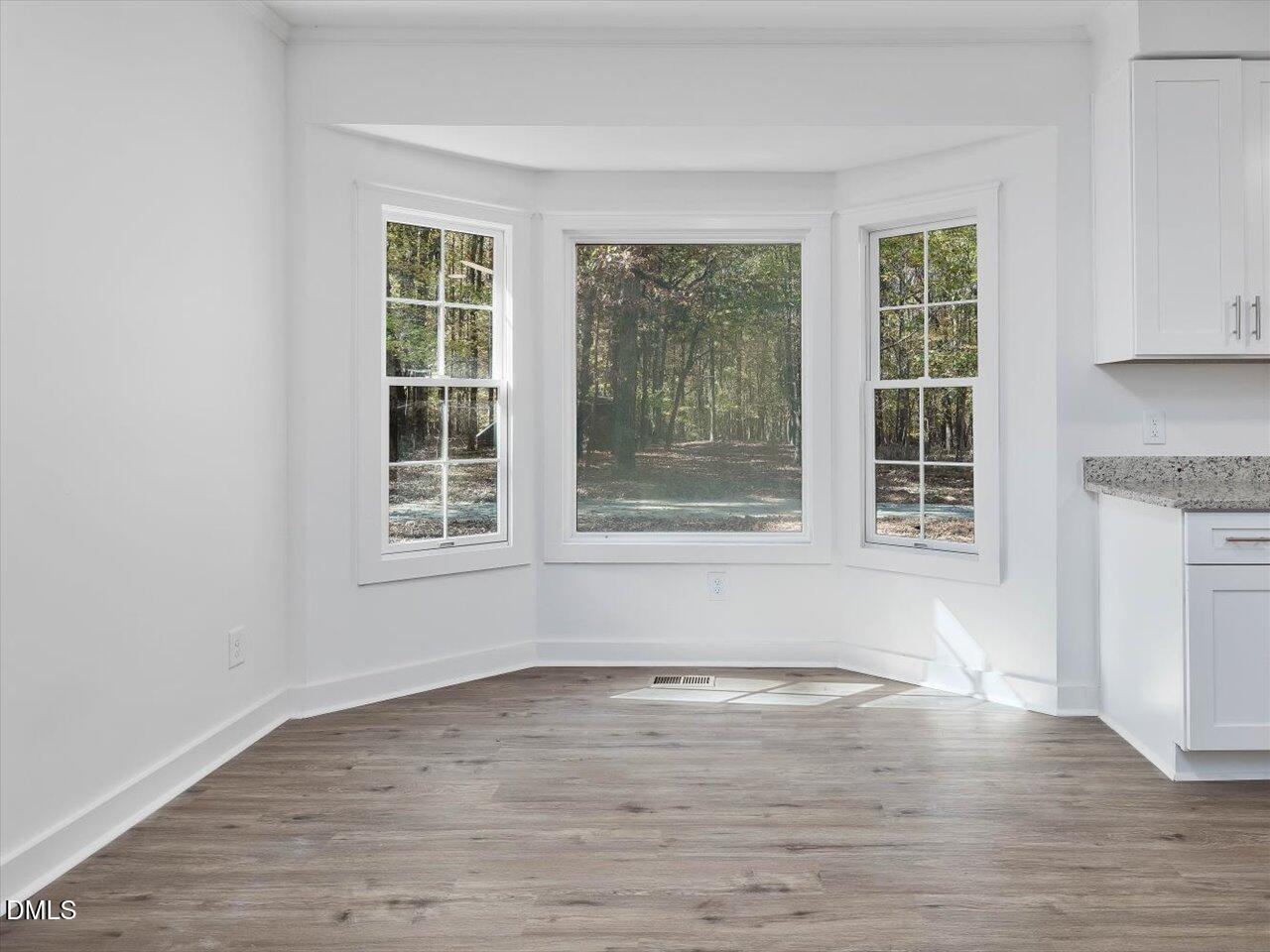 1838 Alex Cockman Road Pittsboro, NC 27312 - Photo 12 of 53 a view of empty room with wooden floor and fan