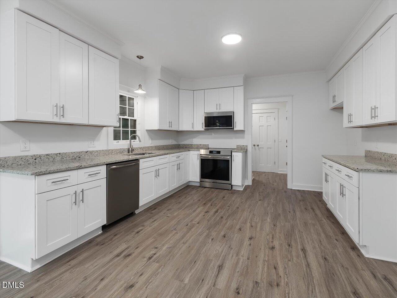 1838 Alex Cockman Road Pittsboro, NC 27312 - Photo 14 of 53 a kitchen with cabinets stainless steel appliances a sink and a stove