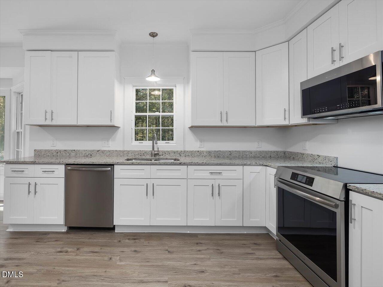 1838 Alex Cockman Road Pittsboro, NC 27312 - Photo 15 of 53 a kitchen with granite countertop white cabinets and appliances