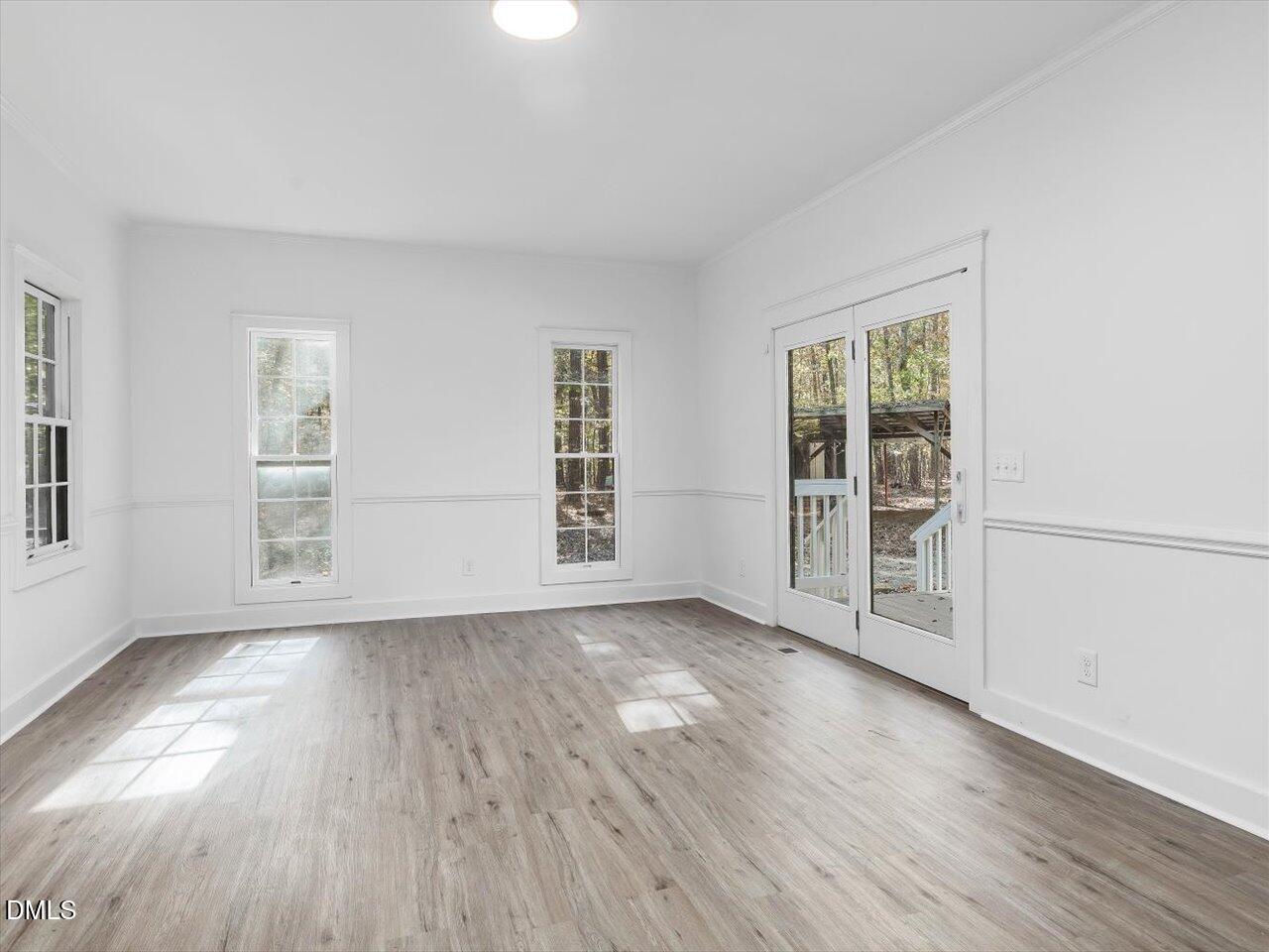 1838 Alex Cockman Road Pittsboro, NC 27312 - Photo 17 of 53 an empty room with wooden floor and windows