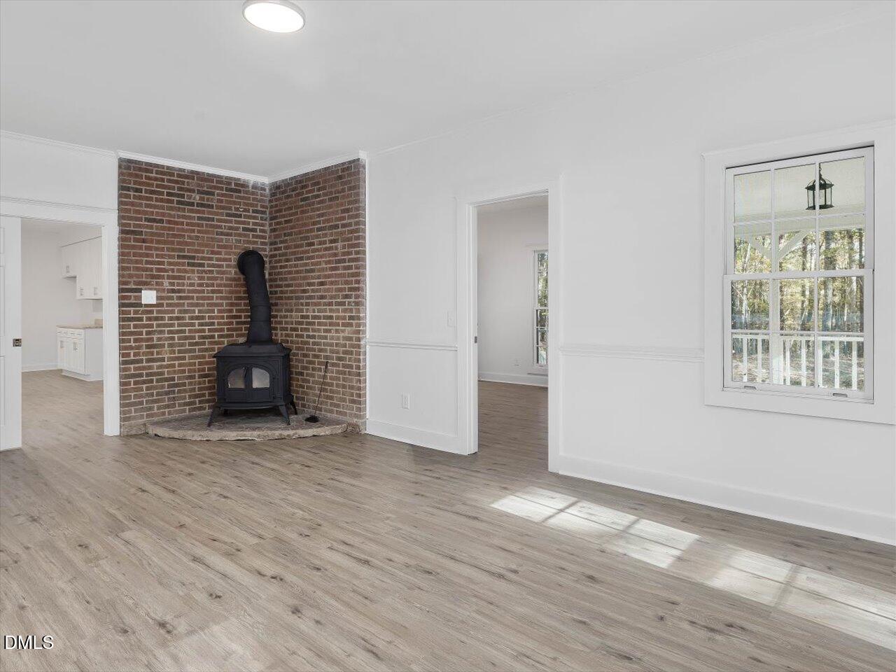 1838 Alex Cockman Road Pittsboro, NC 27312 - Photo 18 of 53 a view of an empty room with wooden floor and a window