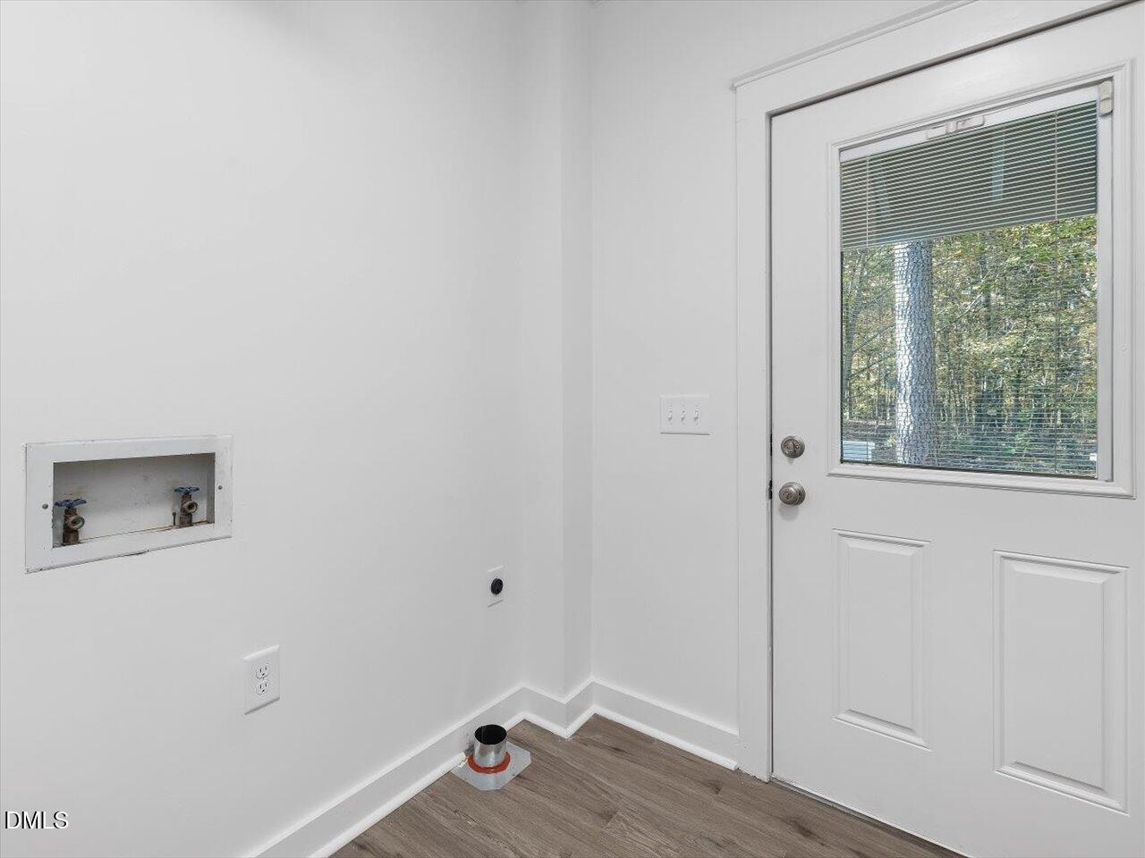 1838 Alex Cockman Road Pittsboro, NC 27312 - Photo 19 of 53 an empty room with a window and wooden floor