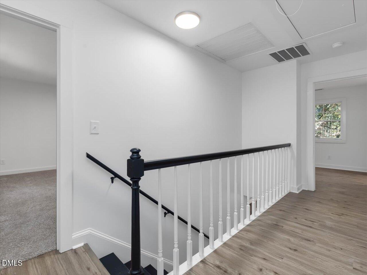 1838 Alex Cockman Road Pittsboro, NC 27312 - Photo 21 of 53 a view of a hallway with wooden floor and staircase