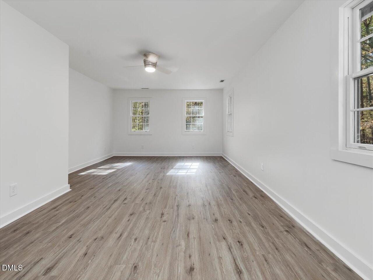 1838 Alex Cockman Road Pittsboro, NC 27312 - Photo 23 of 53 an empty room with wooden floor and windows