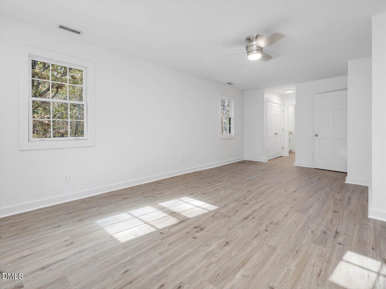 1838 Alex Cockman Road Pittsboro, NC 27312 - Photo 24 of 53 an empty room with wooden floor and windows