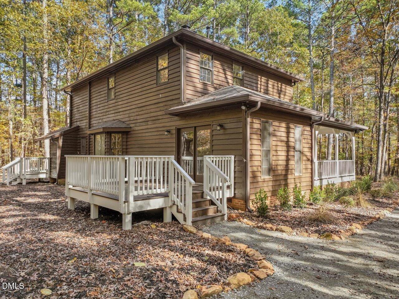 1838 Alex Cockman Road Pittsboro, NC 27312 - Photo 36 of 53 a porch with a bench next to a yard