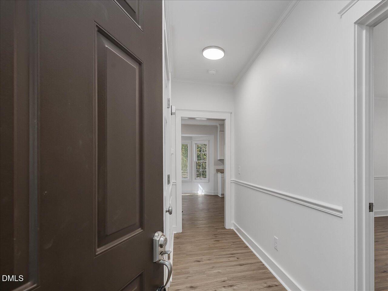 1838 Alex Cockman Road Pittsboro, NC 27312 - Photo 7 of 53 a view of a hallway with wooden floor