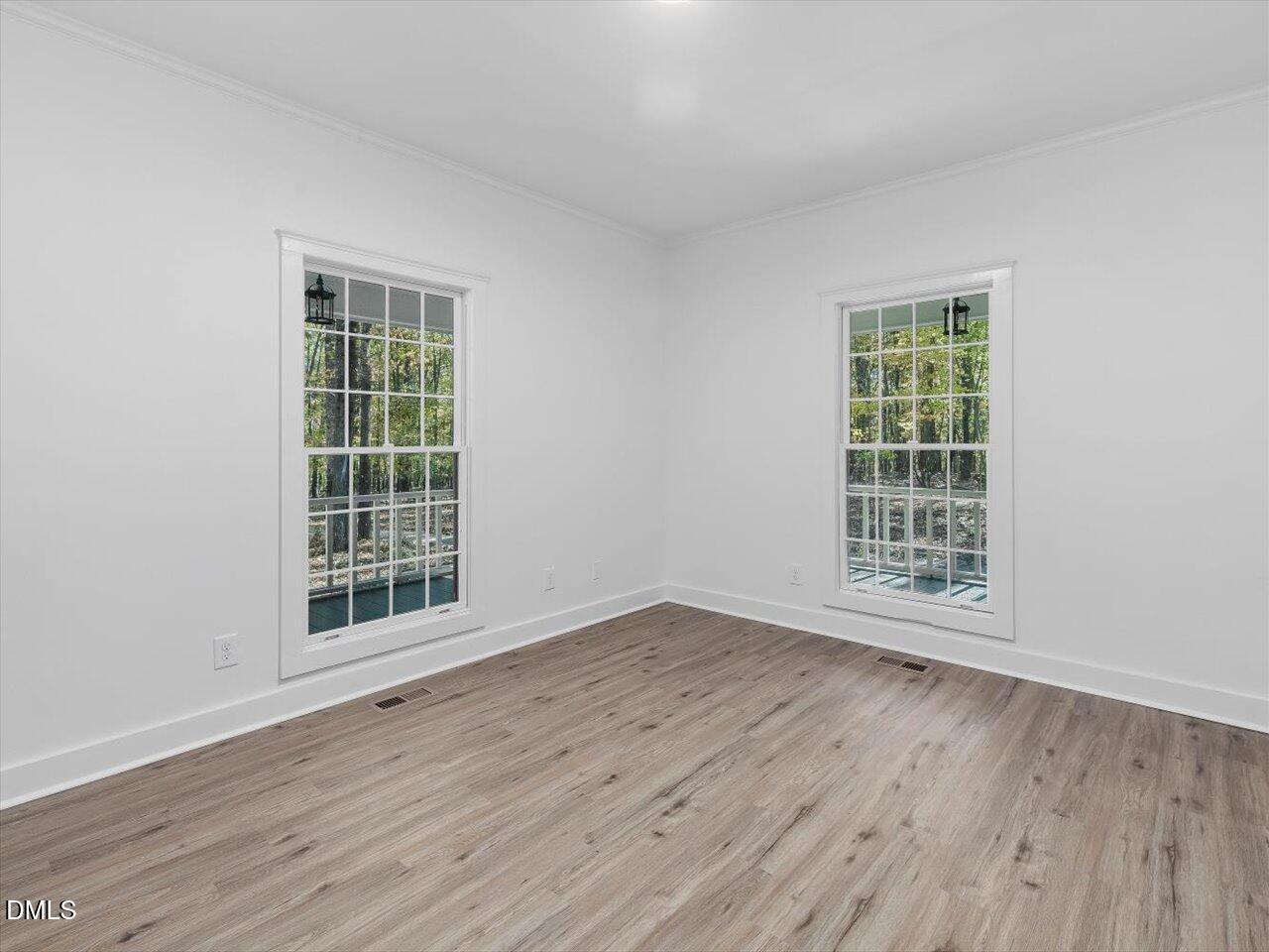 1838 Alex Cockman Road Pittsboro, NC 27312 - Photo 8 of 53 an empty room with wooden floor and windows