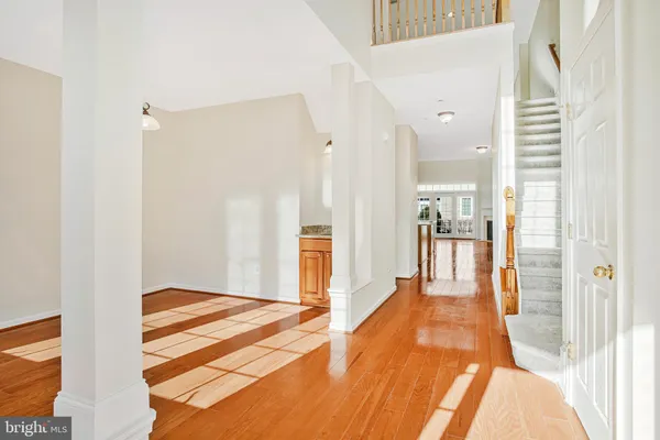 a view of a bedroom with wooden floor and a bathroom