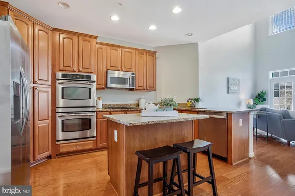 a kitchen with stainless steel appliances granite countertop a sink a stove and cabinets