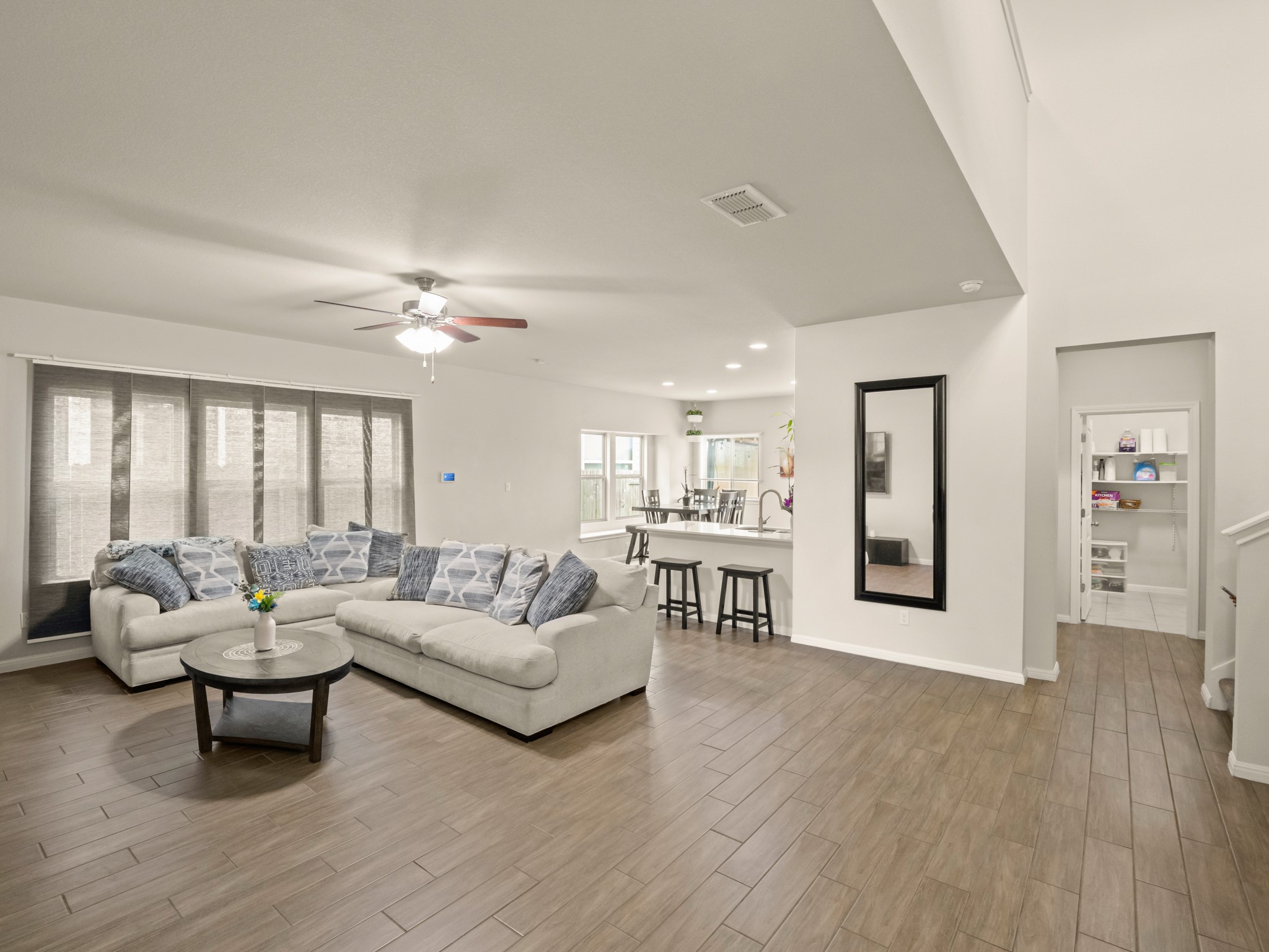 574 Nautical Loop Kyle, TX 78640 - Photo 6 of 23 An inviting open-concept living space features warm wood-look flooring and soaring ceilings.