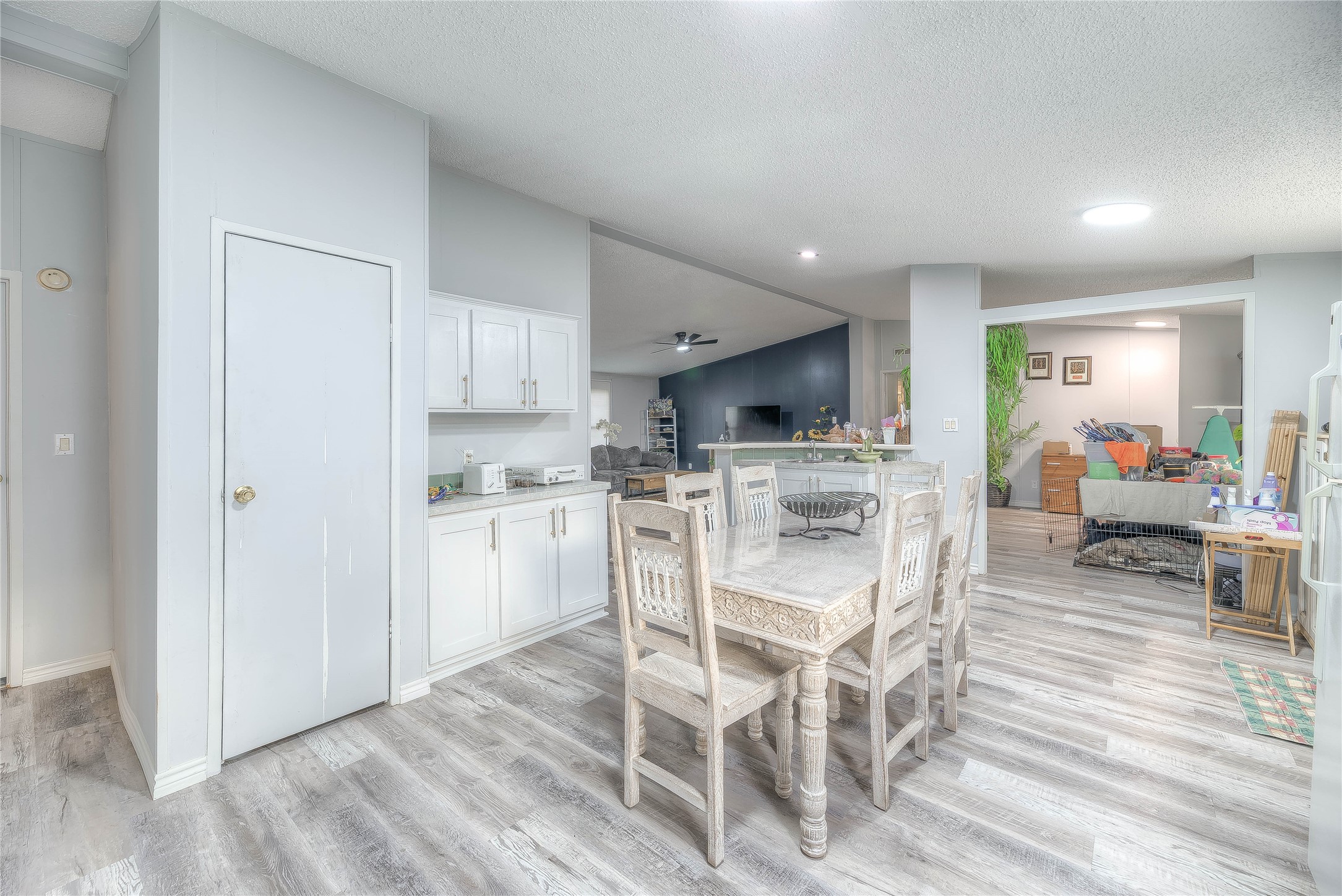 17709 Pine View Drive Conroe, TX 77302 - Photo 15 of 26 a kitchen with a table chairs refrigerator and cabinets