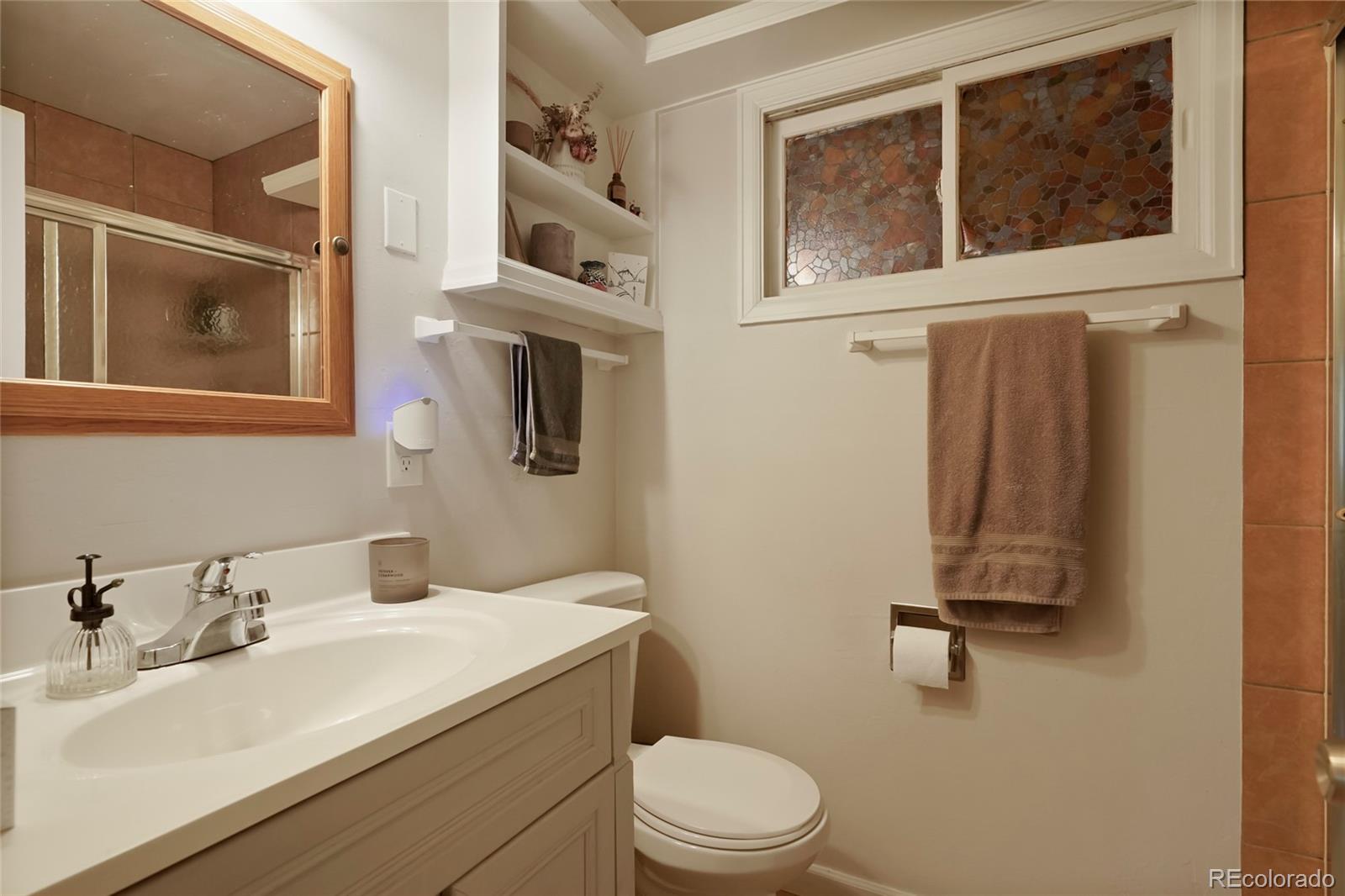4932 Little Cub Creek Road Evergreen, CO 80439 - Photo 10 of 29 a bathroom with a sink mirror vanity and toilet