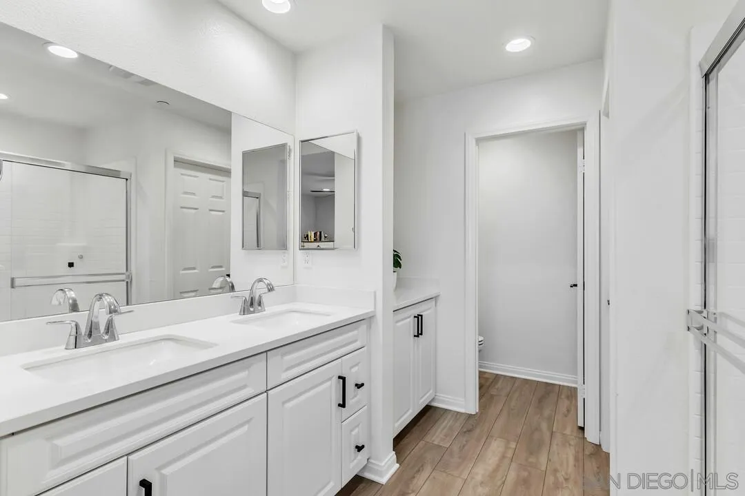 2811 Safflower Street Spring Valley, CA 91977 - Photo 19 of 28 a bathroom with a double vanity sink and mirror