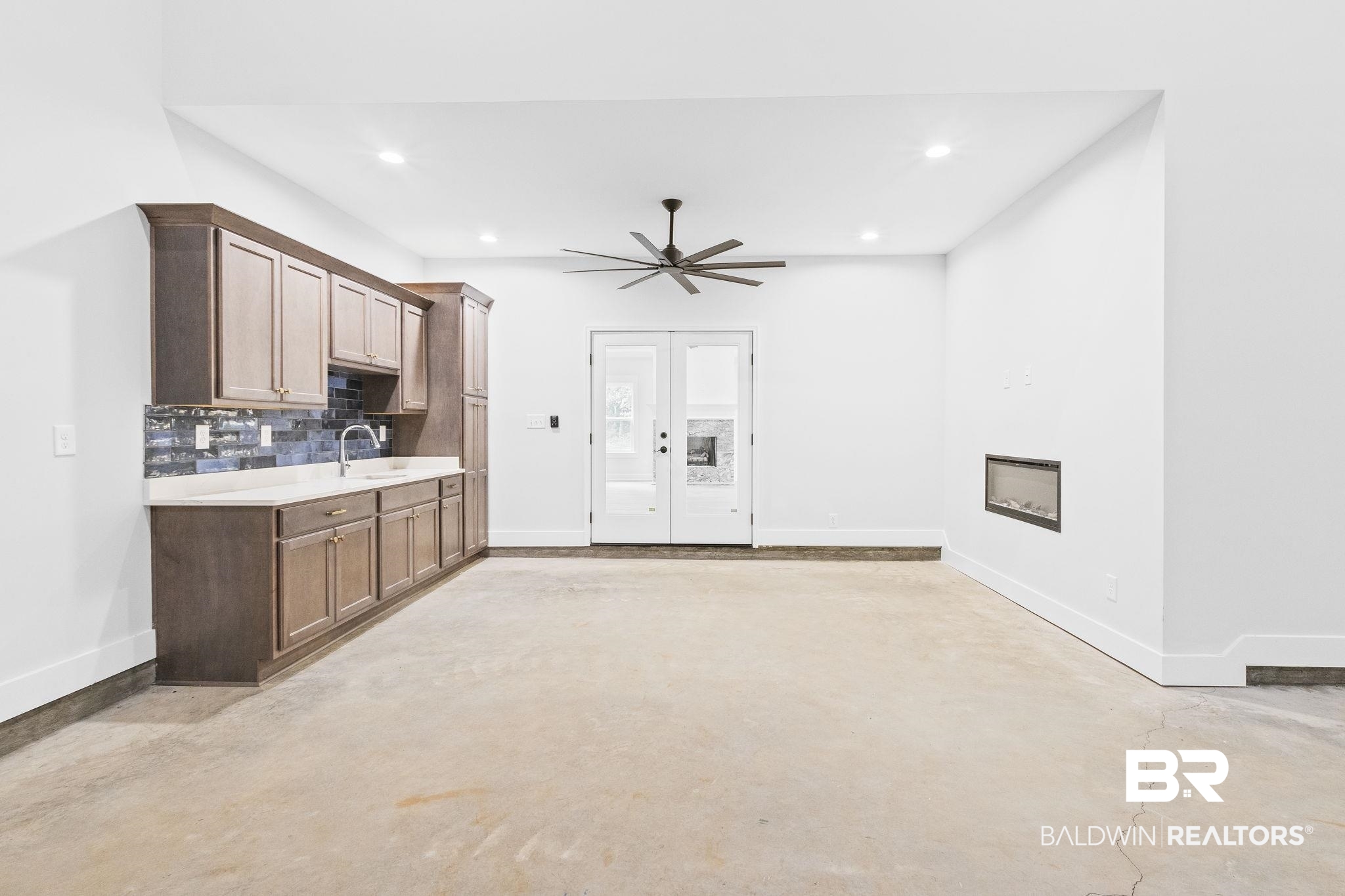 12130 Reunion Place Foley, AL 36535 - Photo 32 of 42 Kitchen featuring sink, ceiling fan, and tasteful backsplash