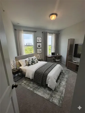 an empty room with windows and fireplace