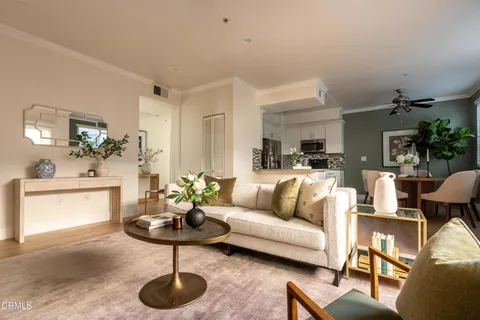 a living room with furniture and a chandelier