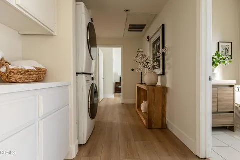 a view of a storage and utility room with closet dryer