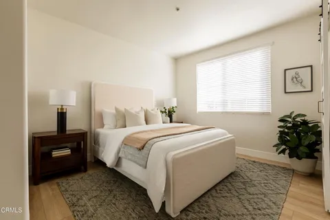 a bedroom with a bed and a potted plant