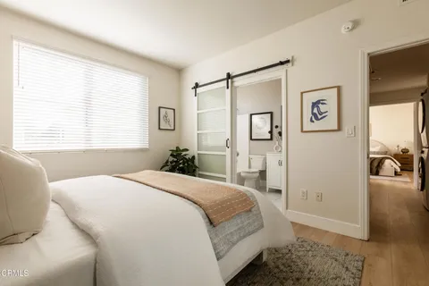 a spacious bedroom with a bed and a window