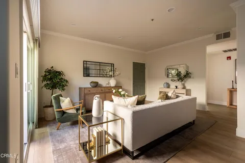 a living room with furniture and a potted plant