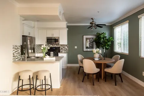 a view of a dining room with furniture window and wooden floor