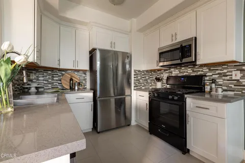 a kitchen with stainless steel appliances a refrigerator stove and microwave