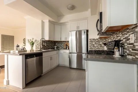 a kitchen with a refrigerator and a sink