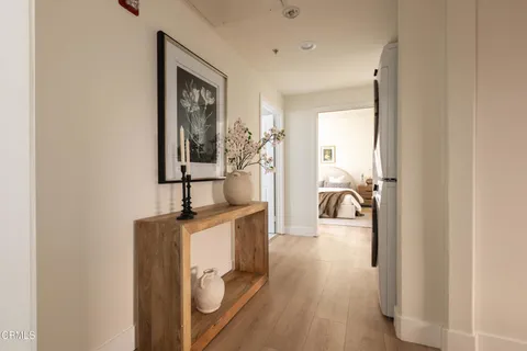 a view of a hallway with living room and furniture