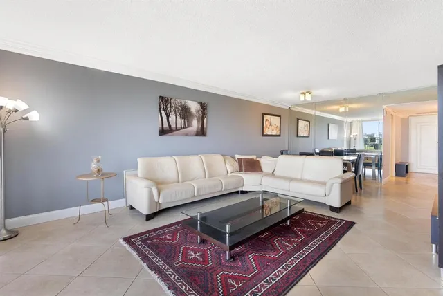 a living room with furniture and a rug