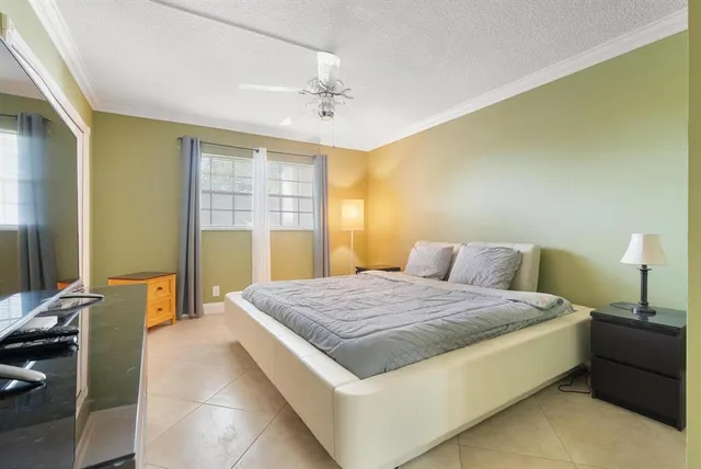 a spacious bedroom with a bed and wooden floor