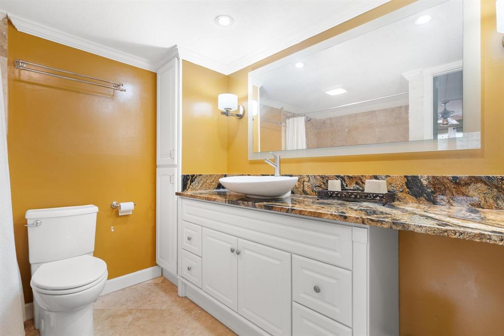 3001 South Palm Aire Drive, Unit 206 Pompano Beach, FL 33069 - Photo 14 of 31 a bathroom with a granite countertop sink mirror vanity and toilet