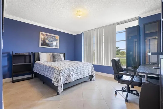 a bedroom with a bed and a desk