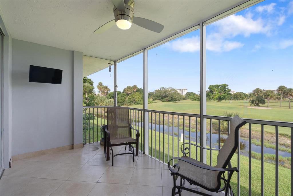 3001 South Palm Aire Drive, Unit 206 Pompano Beach, FL 33069 - Photo 19 of 31 a balcony with furniture and a swing