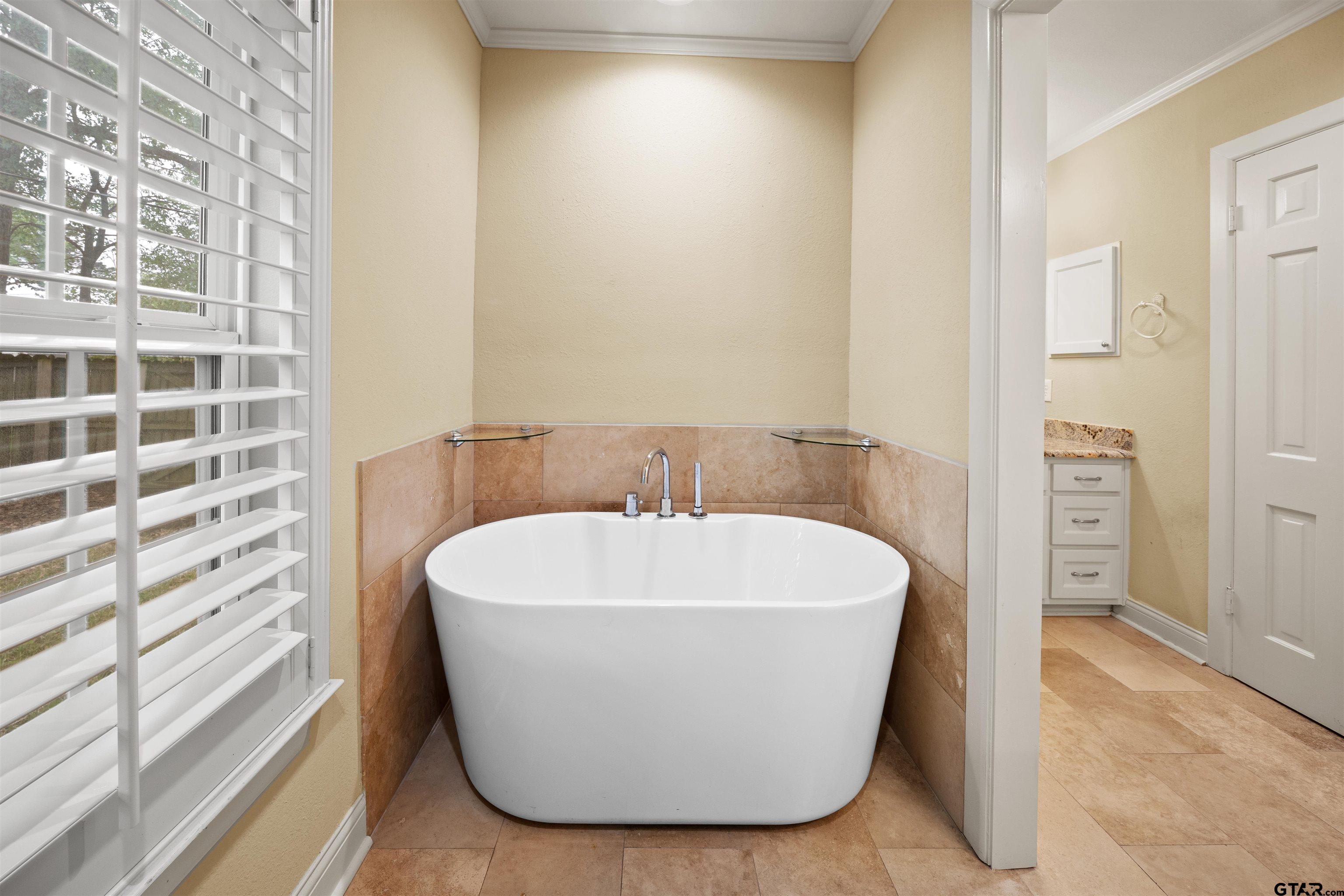 711 South Prairieville Street Athens, TX 75751 - Photo 19 of 27 a white bath tub sitting in a bathroom