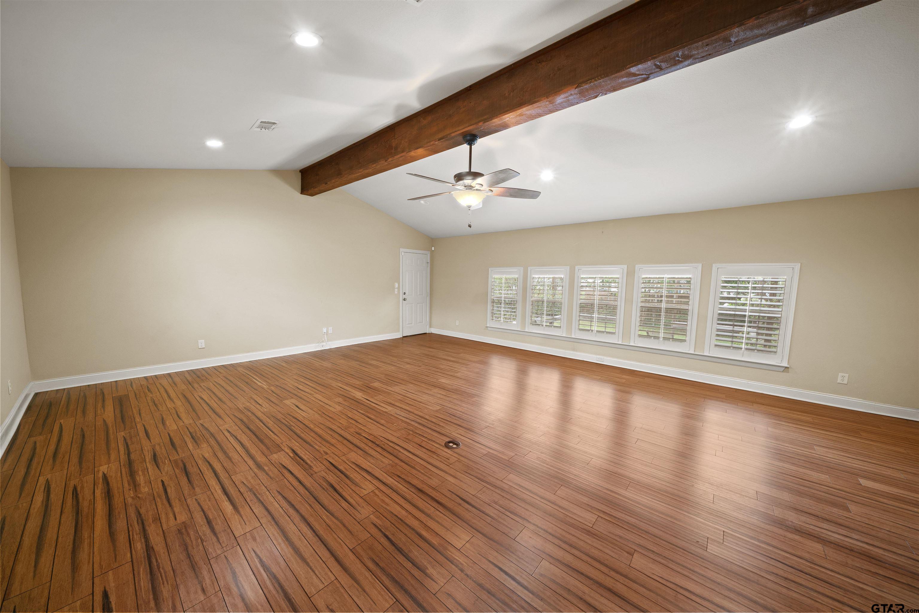 711 South Prairieville Street Athens, TX 75751 - Photo 3 of 27 a view of an empty room with wooden floor and a window