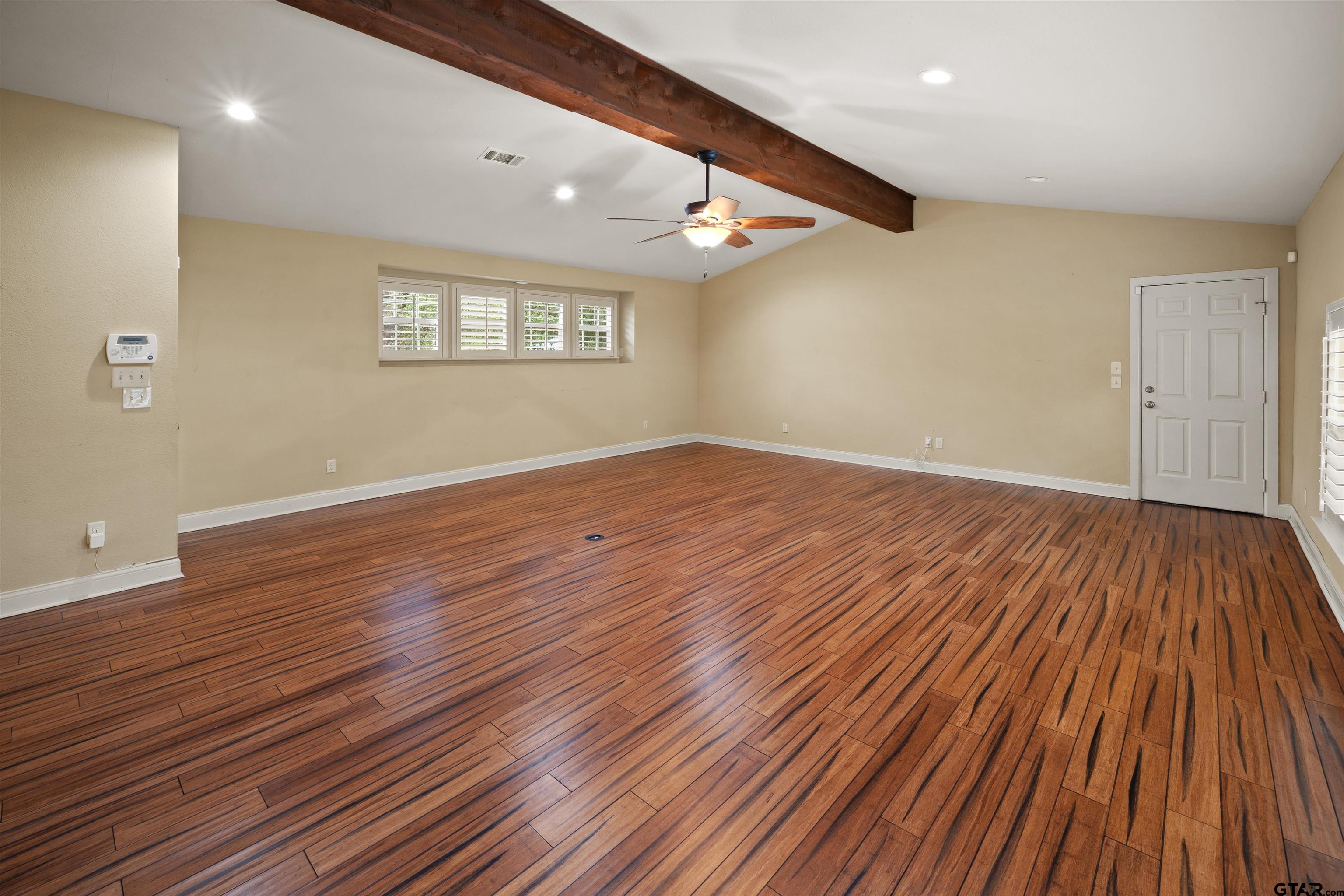 711 South Prairieville Street Athens, TX 75751 - Photo 4 of 27 an empty room with wooden floor and windows