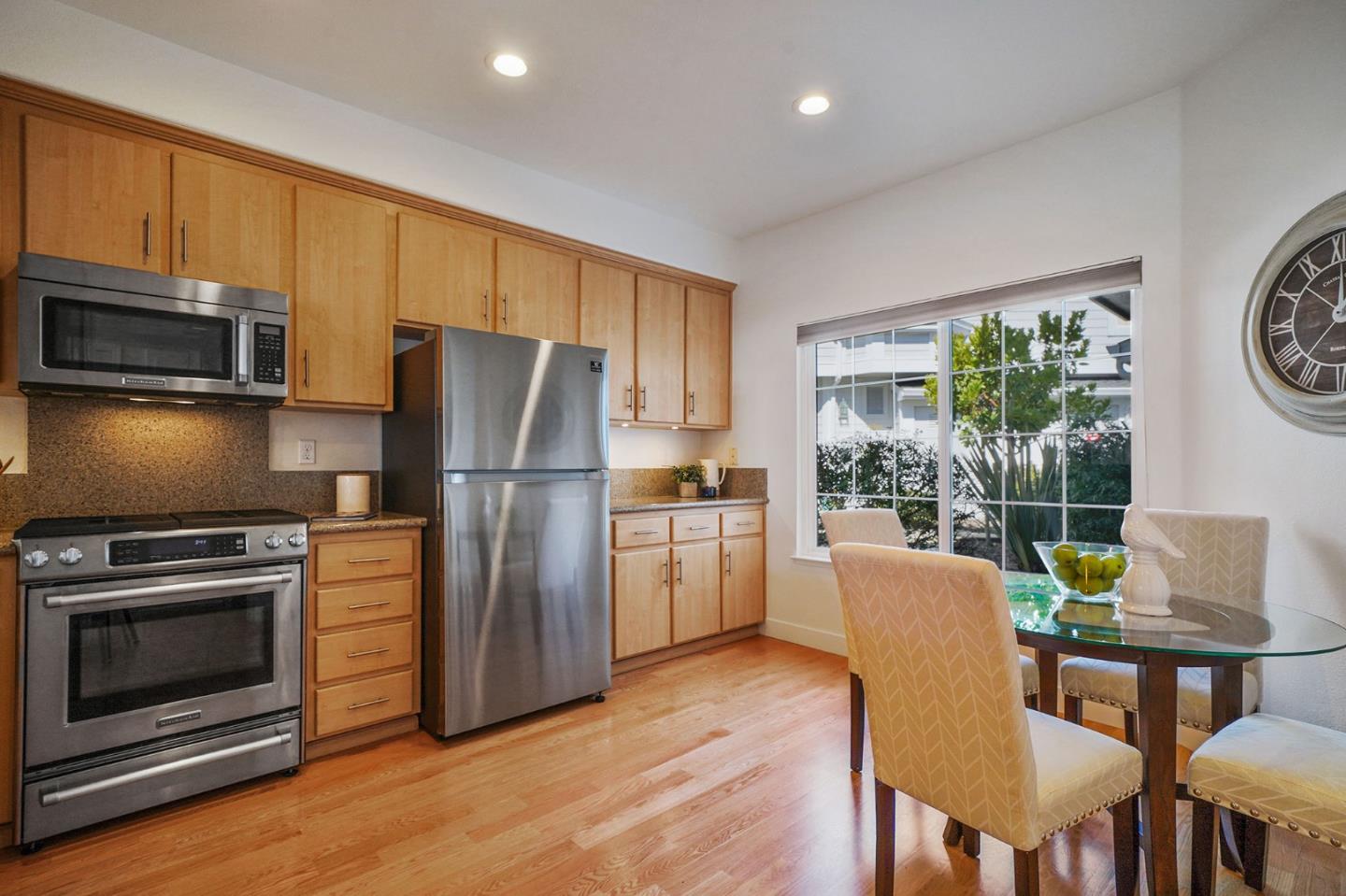 45 Outlook Circle Pacifica, CA 94044 - Photo 8 of 42 a kitchen with stainless steel appliances a stove a refrigerator a dining table and chairs