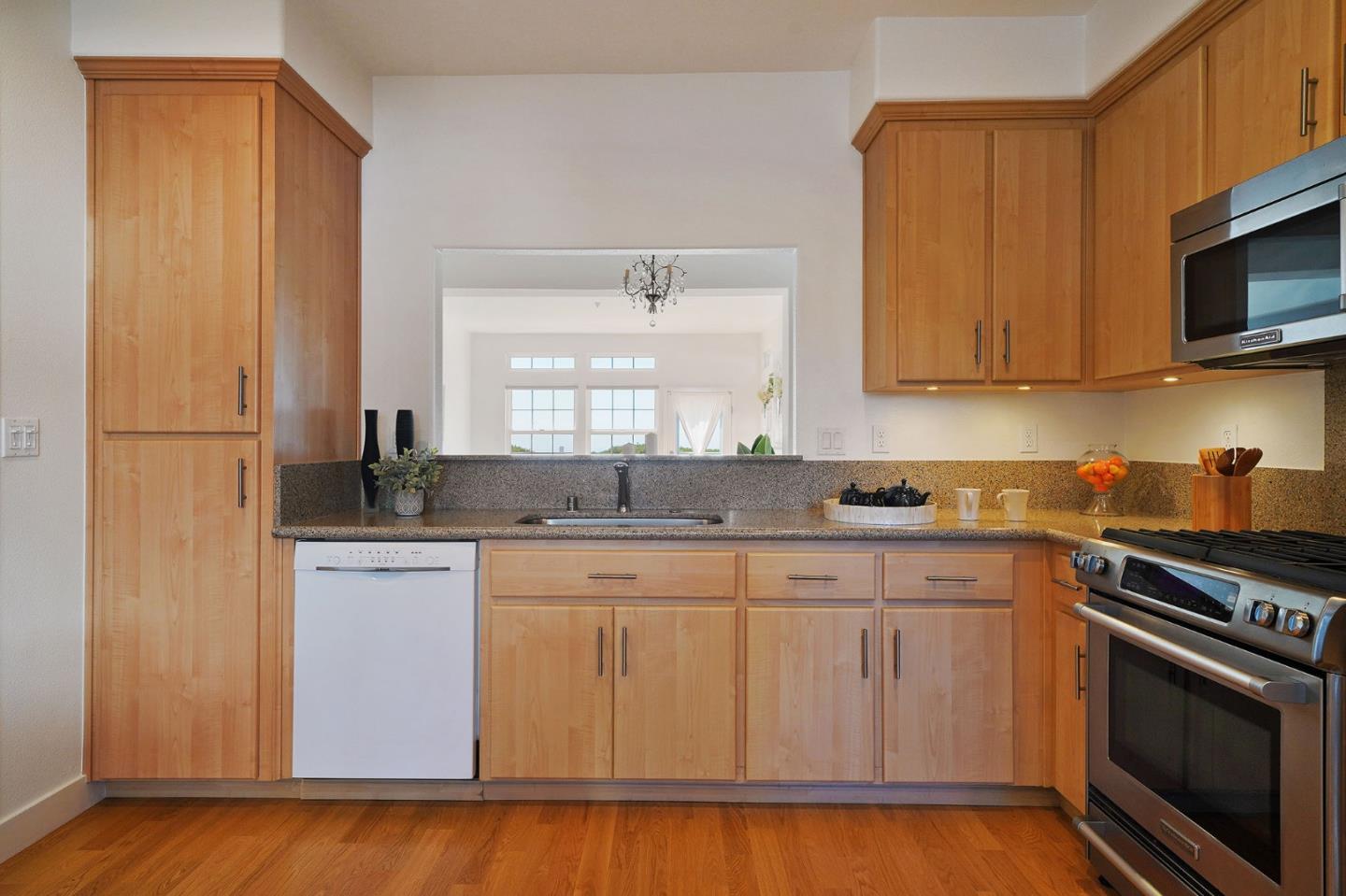 45 Outlook Circle Pacifica, CA 94044 - Photo 9 of 42 a kitchen with stainless steel appliances granite countertop a stove a sink and a microwave