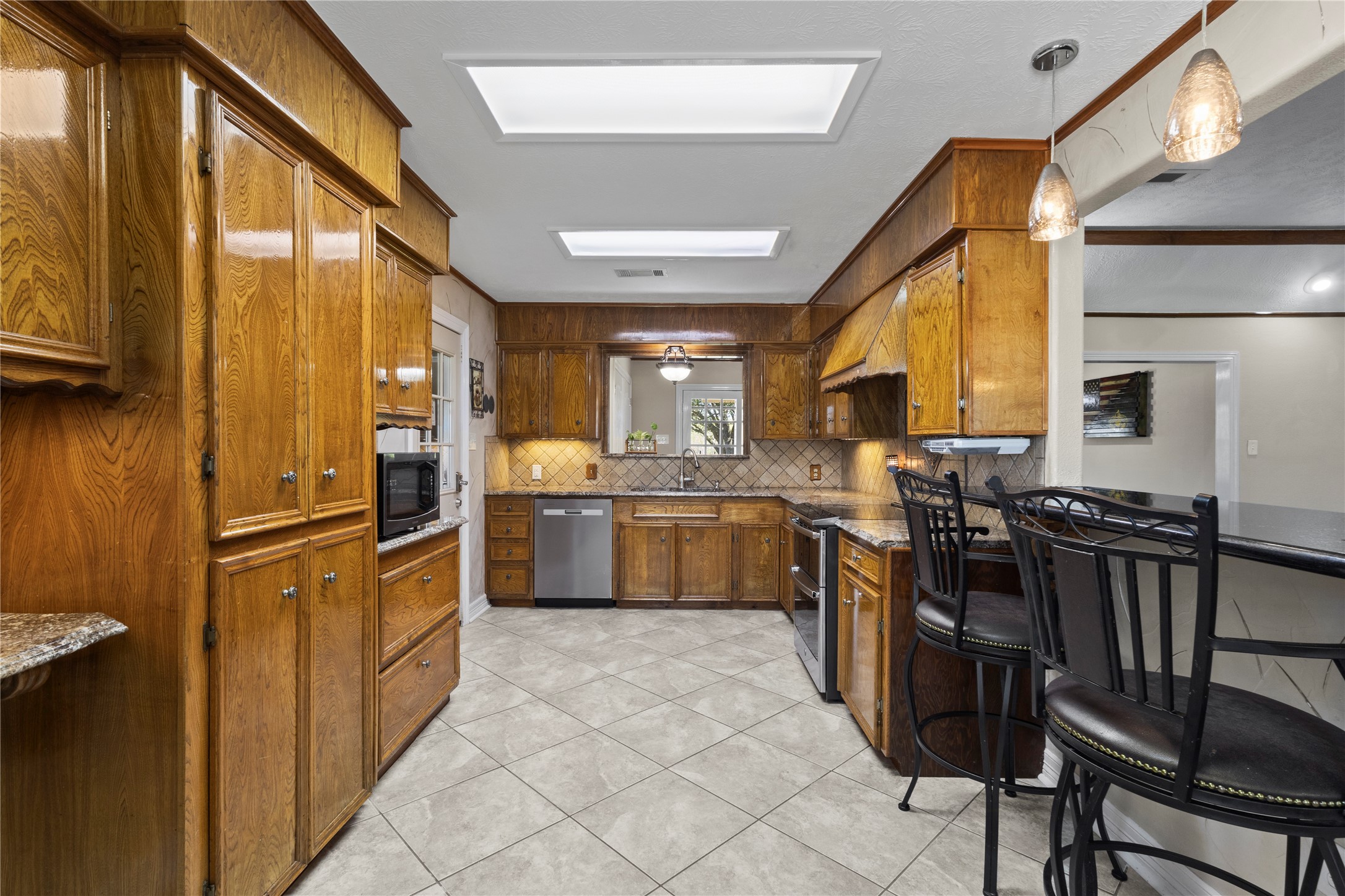 11546 Davidson Road Beaumont, TX 77705 - Photo 17 of 40 a kitchen with granite countertop a sink stainless steel appliances and cabinets