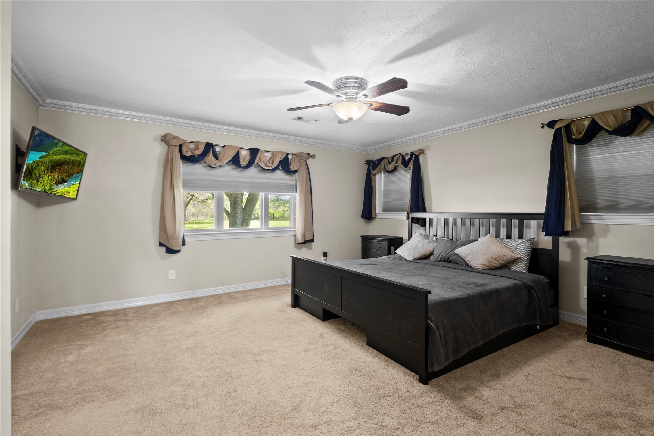 11546 Davidson Road Beaumont, TX 77705 - Photo 21 of 40 a bedroom with a bed and a chandelier