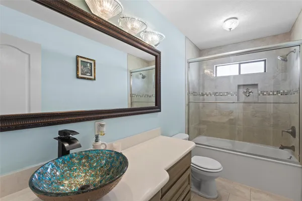 a bathroom with a sink a toilet and bathtub