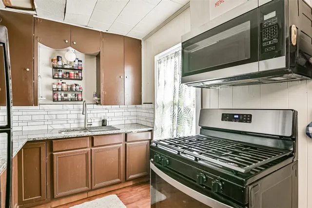 a kitchen with a stove and a microwave