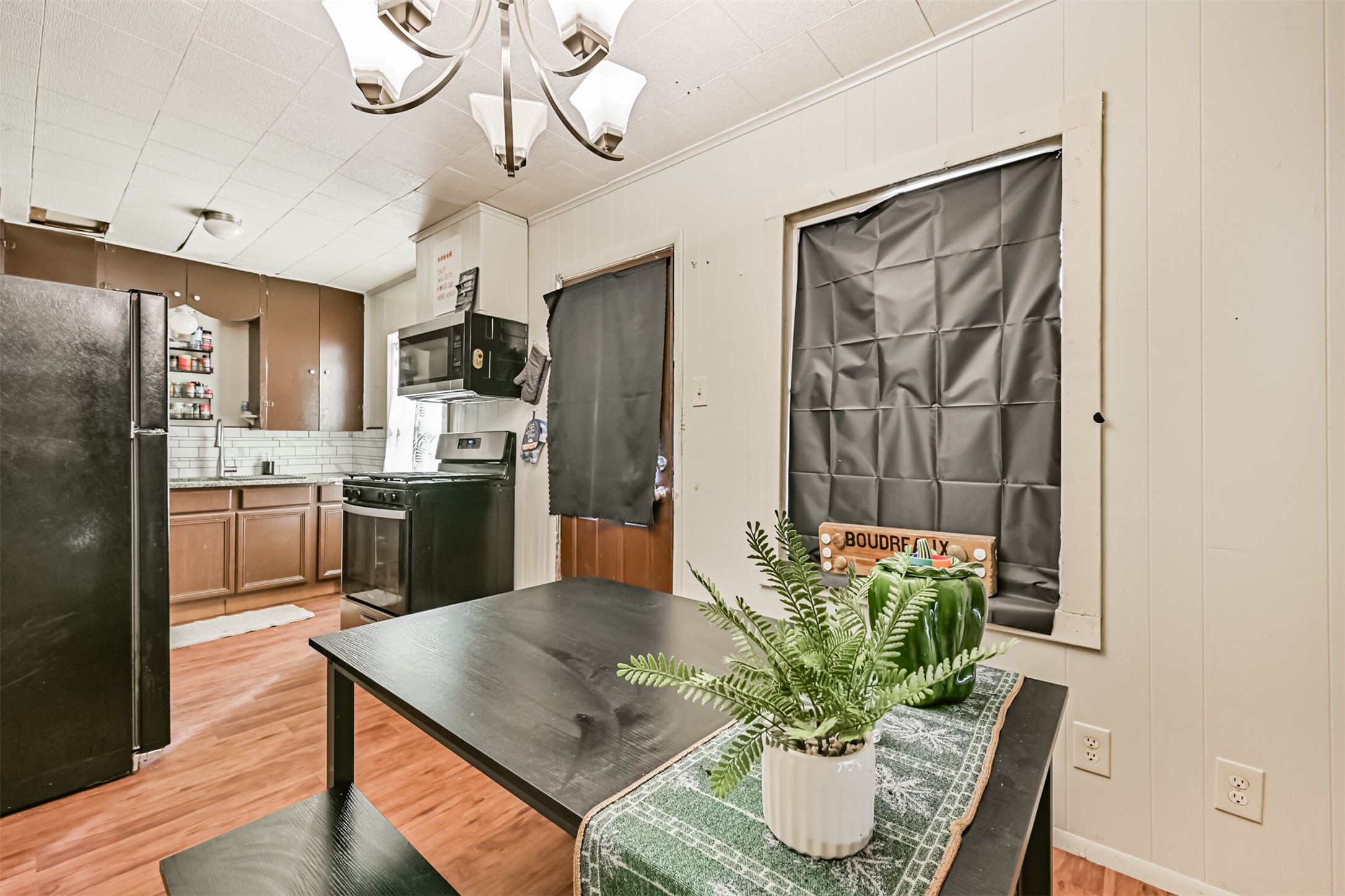 707 West 5th Street Freeport, TX 77541 - Photo 13 of 18 a kitchen with stainless steel appliances granite countertop a refrigerator a sink a stove and chairs