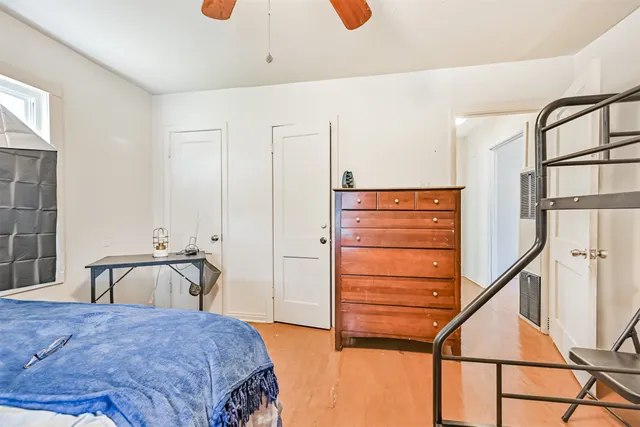 a bedroom with a bed and a dresser