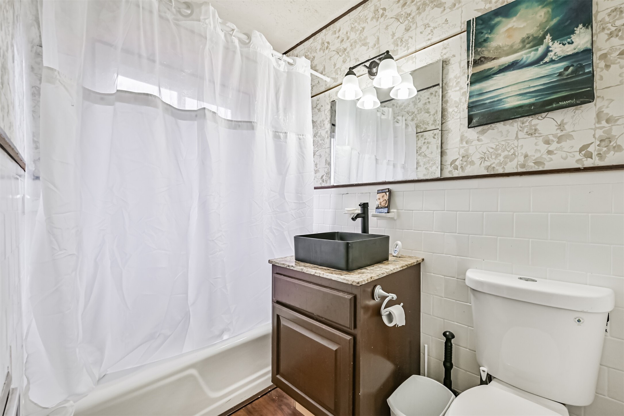 707 West 5th Street Freeport, TX 77541 - Photo 7 of 18 a bathroom with a sink a toilet and shower
