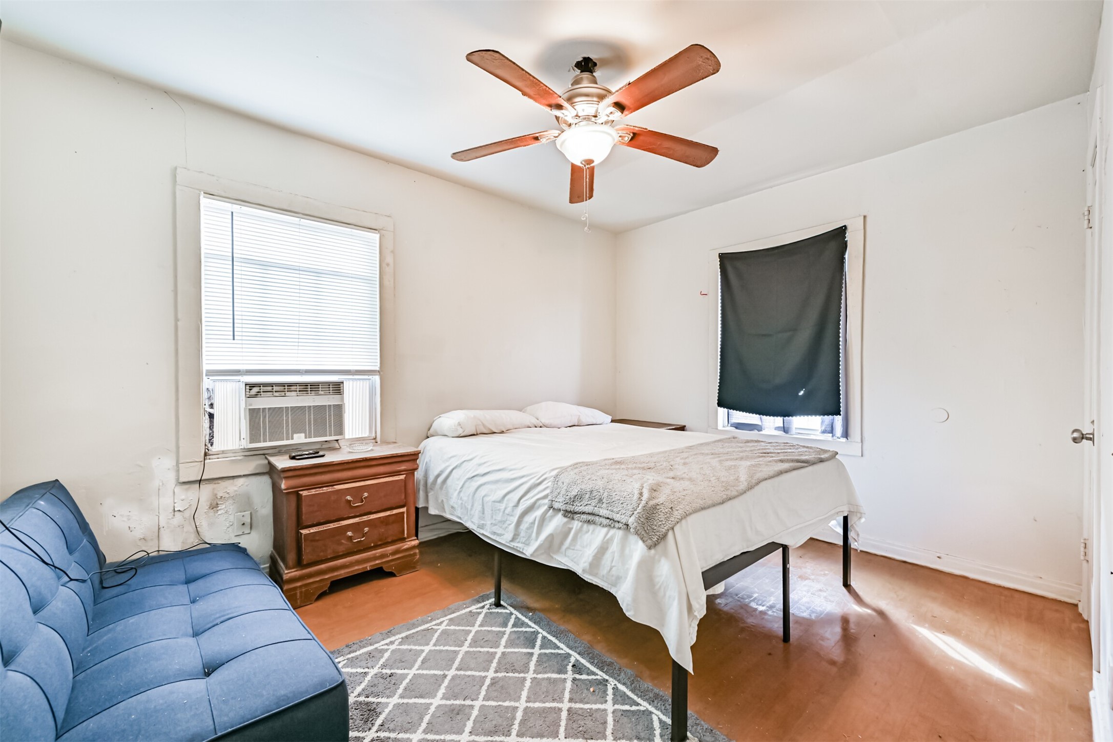 707 West 5th Street Freeport, TX 77541 - Photo 9 of 18 a bedroom with a bed couches and window